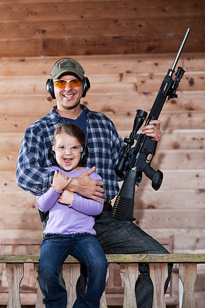 istock Girl with father holding rifle. 187041244