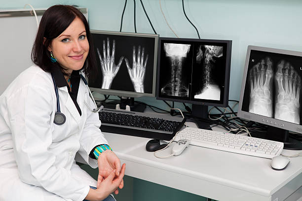 istock Young radiologist in her office examinig x-ray images 187041540