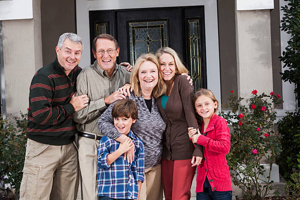 istock Multi-generation family standing together in front of house 187041805