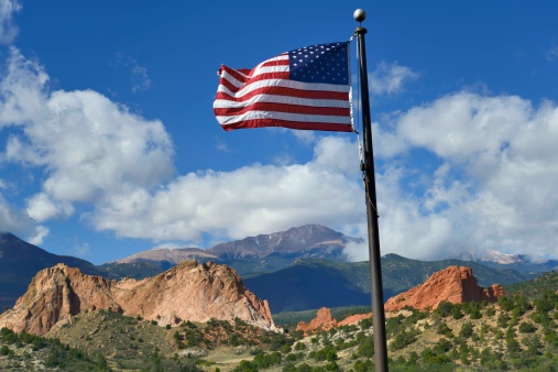 An American flag with the beautiful Garden of the Gods Park in the background in Colorado Springs.