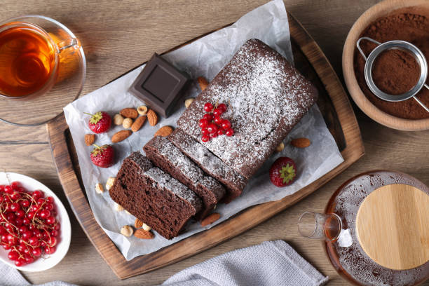 istock Tasty chocolate sponge cake served on wooden table, flat lay 1870420613