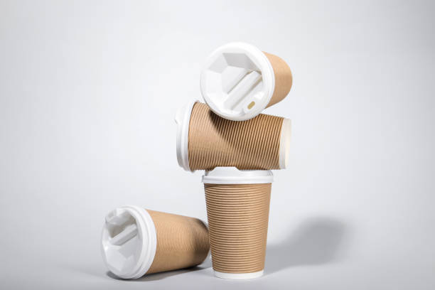 istock Paper cups with white lids on light gray background. Coffee to go 1870421662