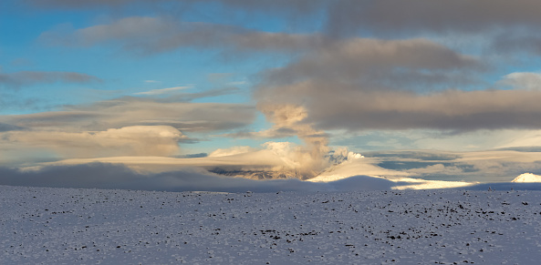 Beautiful, amazing and spectacular high altitude landscape between Arequipa and Chivay, Peru. Andean mountains covered with snow, clouds, morning light.