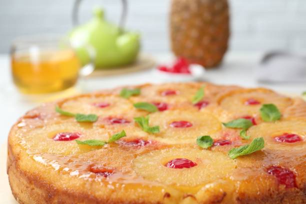 istock Tasty pineapple cake with cherries and mint on table, closeup 1870423218