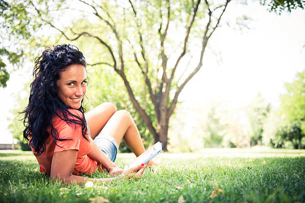 istock Woman using digital tablet at the park 187042377