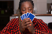 Teenager girl Playing Cards at home
