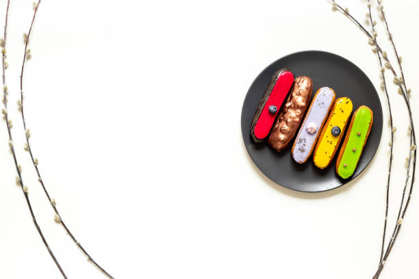 Set of various glased eclairs with chocolate and berrie, top view