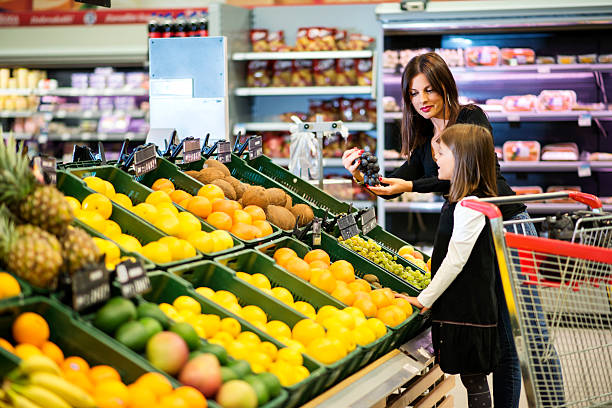 istock Mother and daughter buying fruit together 187044483