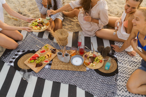 istock Girls having a picnic on the beach 1870444883