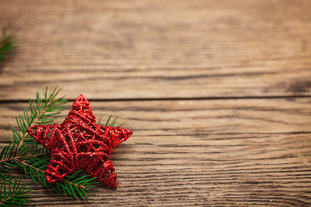 istock Red Christmas star on grungy wooden plank 187044656
