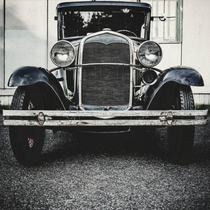 A front view of an old Ford Model T from the 1920's.  Shot in desaturated vintage style.  Square crop.