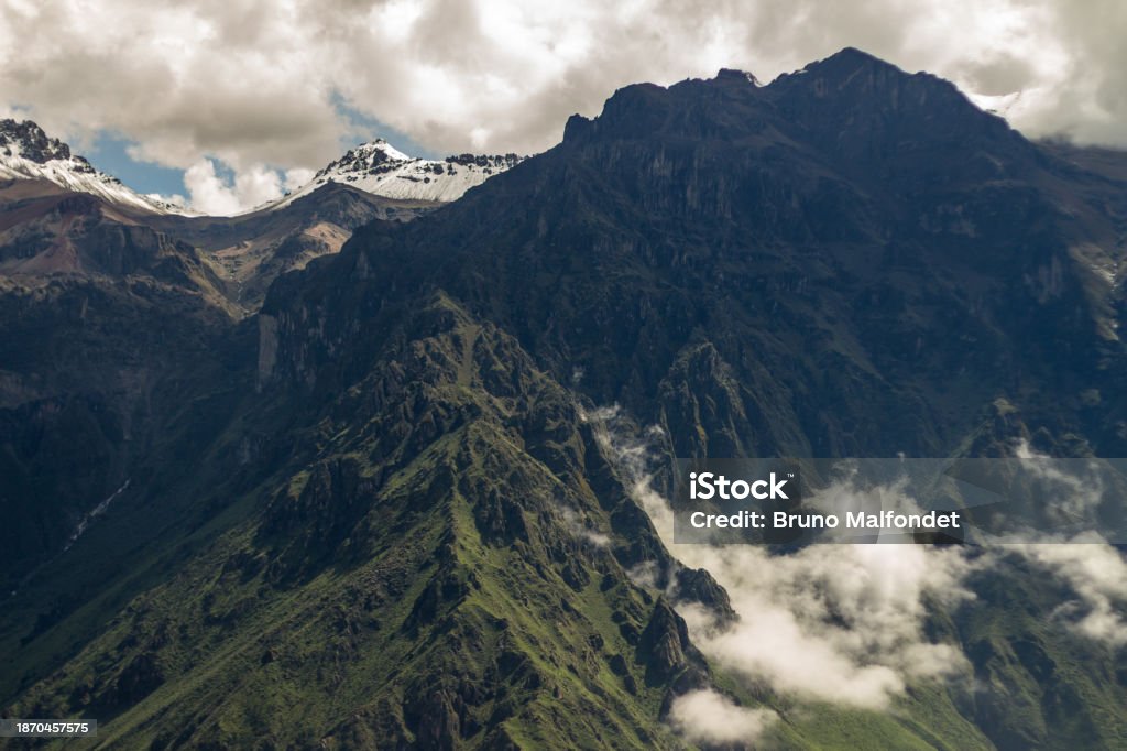 Spectacular mountain range in the Colca Canyon, Peru. Above the clouds. Very high altitude. White clouds, blue sky. Snow. Altiplano Stock Photo Spectacular mountain range in the Colca Canyon, Peru. Above the clouds. Very high altitude. White clouds, blue sky. Snow. Altiplano Stock Photo