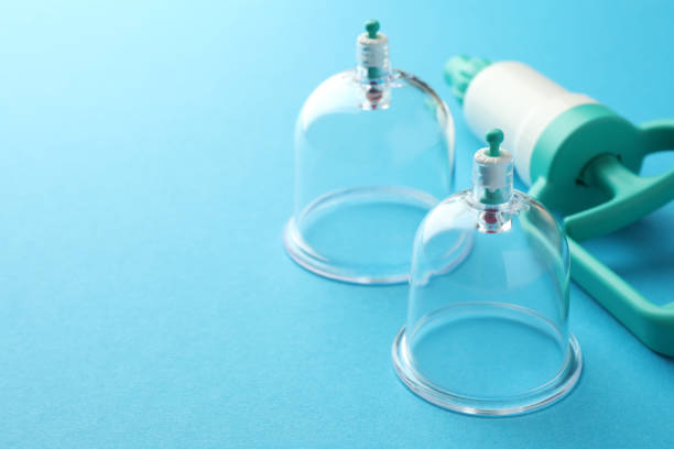 istock Plastic cups and hand pump on light blue background, closeup with space for text. Cupping therapy 1870460719