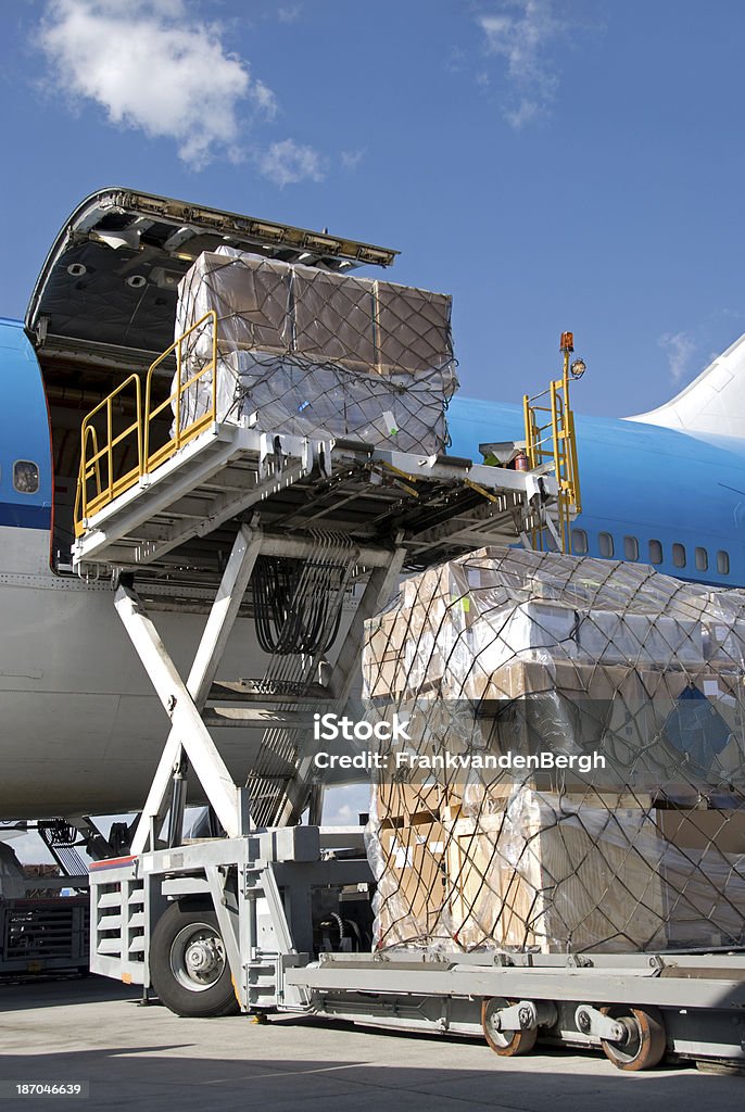 Cargo Handling Loading cargo into an airplane. Cargo Container Stock Photo
