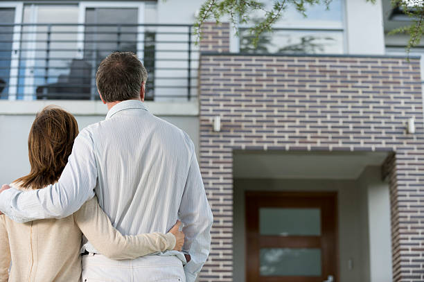 istock Mature couple looking at a house 187047392