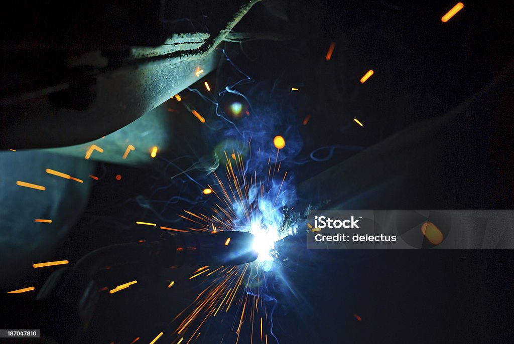 Electric arc and sparks when welding Electric arc and sparks when welding. Repair to an exhaust system. Activity Stock Photo