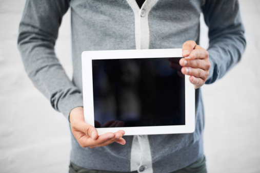 Cropped image of a nerd holding a digital tablet