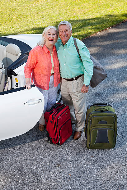 istock Senior couple with suitcases and convertible 187048337
