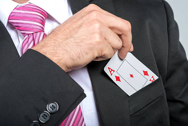 istock businessman pulling out his pocket aces cards 187048383