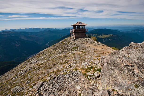 Historic Mount Fremont Fire Lookout The Mount Fremont Fire Lookout is a rustic style building in the northern part of Mount Rainier National Park. It sits on top of a rocky outcrop at an elevation of 7317 feet above sea level. The building is maintained as a historic structure and is no longer used as a fire lookout. The lookout was placed on the National Register of Historic Places on March 13, 1991. Mount Fremont Lookout is located near Sunrise in Mount Rainier National Park, Washington State, USA. jeff goulden fire lookout stock pictures, royalty-free photos & images