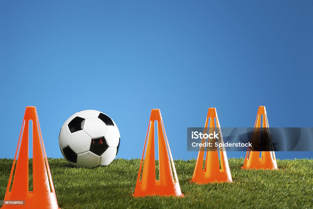 Soccer Ball With Cones Soccer ball on green grass with orange cones Cone Shape Stock Photo