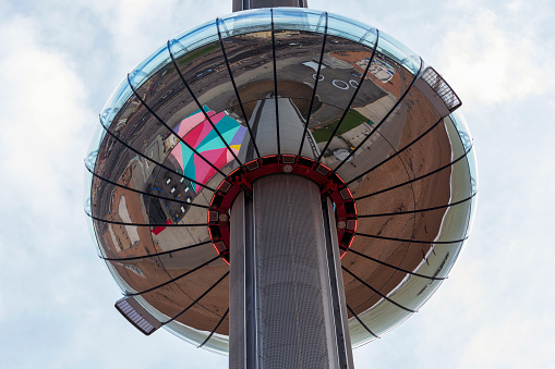 Brighton, UK - Nov 12, 2023: the reflective people-carrying pod of the British Airways i360 tower alongside a dazzling blue summer sky in Brighton, UK. The tower elevates people to stunning views of the famous British seaside town.