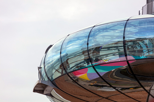 Brighton, UK - Nov 12, 2023: the reflective people-carrying pod of the British Airways i360 tower alongside a dazzling blue summer sky in Brighton, UK. The tower elevates people to stunning views of the famous British seaside town.