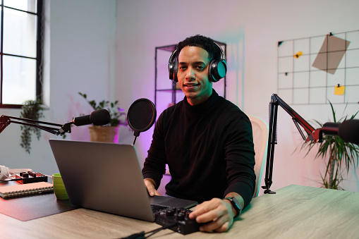 Young man filming a podcast at his home studio.