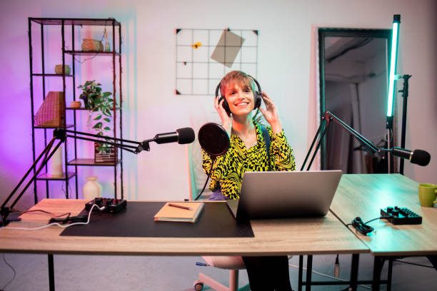 istock Happy young woman working at her home broadcast studio 1870491579