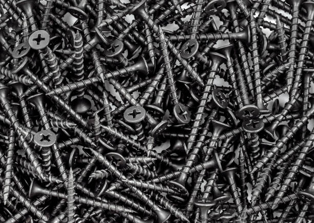 istock Black self-tapping screws as industrial background. Top view. 1870510819