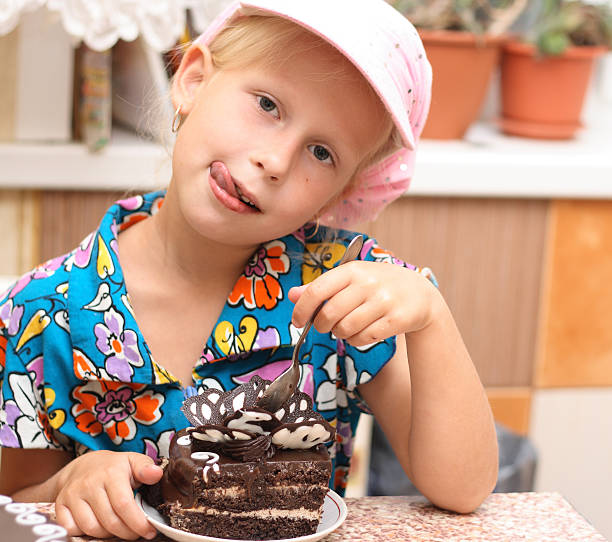 istock Little Girl Eating Chocolate Cake 187051301