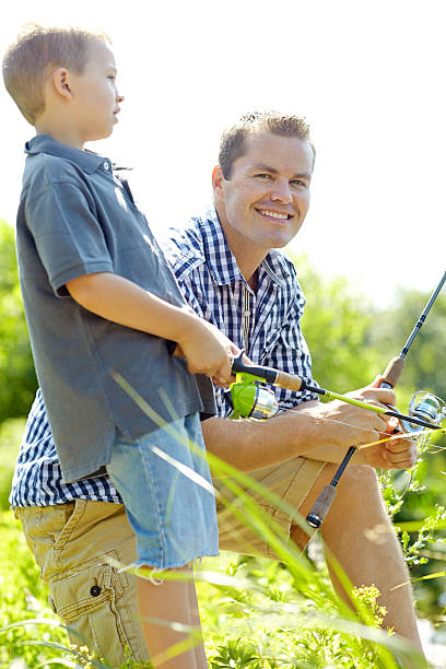 istock Two patient boys beside the lake 187051630