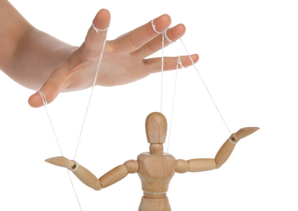 istock Woman pulling strings of puppet on white background, closeup 1870518735