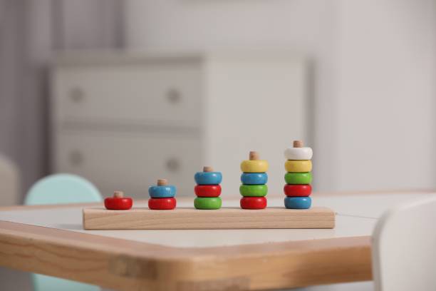 istock Stacking and counting game wooden pieces on table indoors, space for text. Educational toy for motor skills development 1870518738