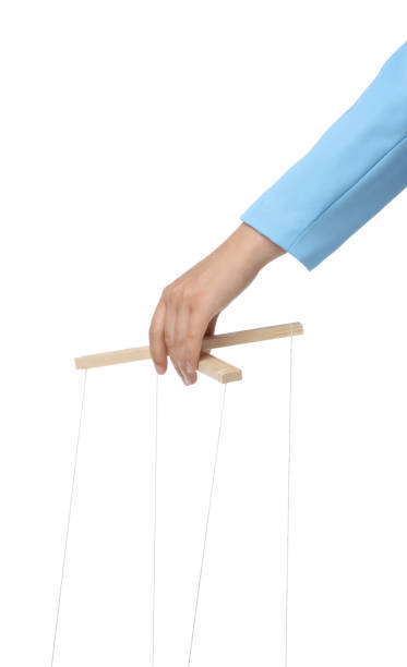 istock Woman pulling strings of puppet on white background, closeup 1870519260