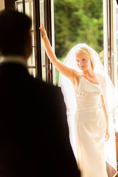 istock Newlywed Couple Looking At Each Other on wedding day 187051927