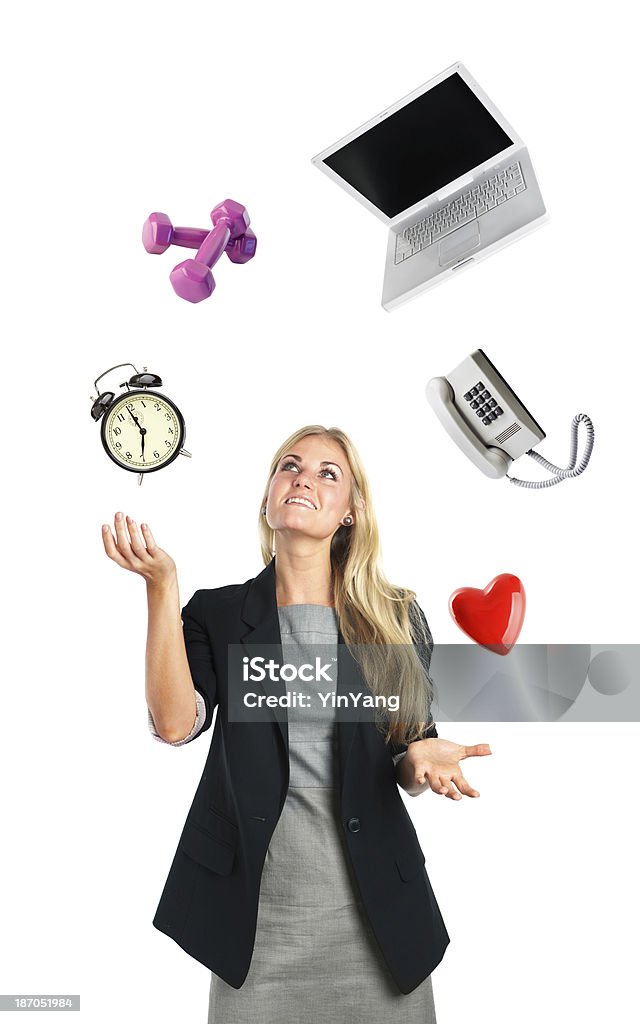 Busy Businesswoman Lifestyle Juggling Act of Work and Home Life Subject: A young businesswoman juggles objects that represent the challenges of balancing work and home life time, exercise, love, communication, and connectivity or assignment duties in a contemporary working class lifestyle. Juggling Stock Photo