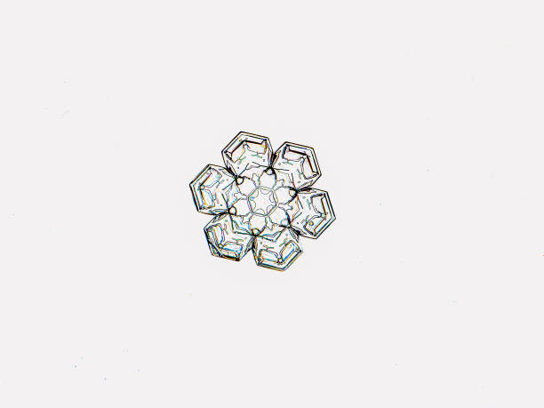A small, symmetrical snowflake on white background