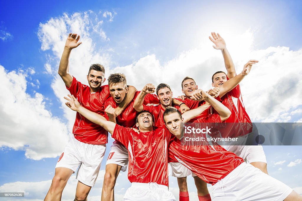Successful soccer team against the sky. Cheerful soccer team celebrating their success against the sky.    Celebration Stock Photo