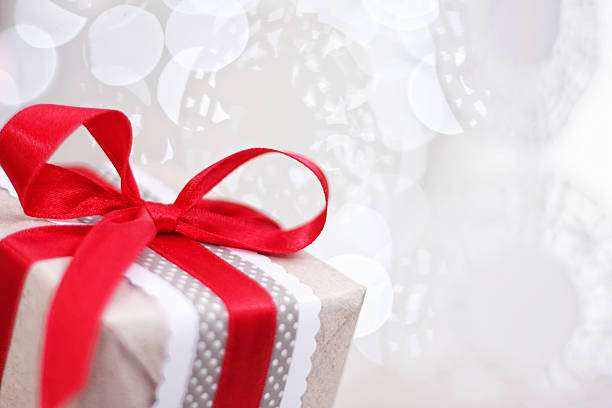 istock Christmas present wrapped in brown paper and red bow 187053088