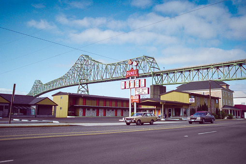 Astoria, Oregon, USA - May 12, 1992 - Archival view of the Dunes Motel and Astoria bridge over the Columbia river.  Shot on film.