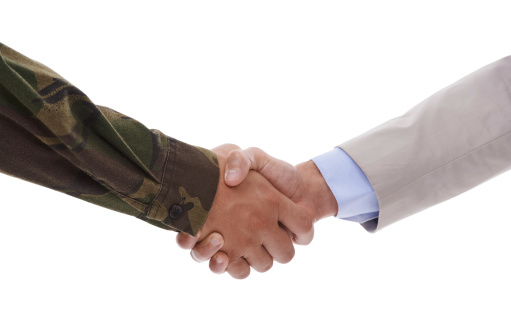 Handshake between a soldier and businessman