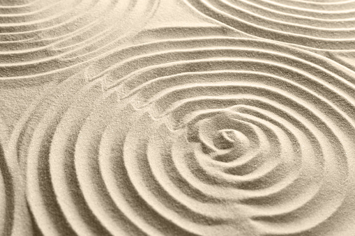 Beautiful patterns on sand, closeup. Zen garden