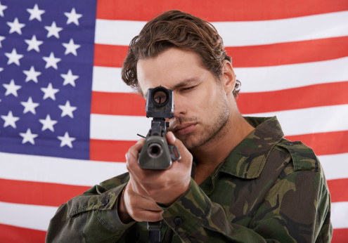 An American soldier pointing his rifle at you