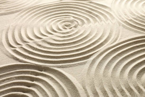 istock Beautiful spirals on sand, closeup. Zen garden 1870554444