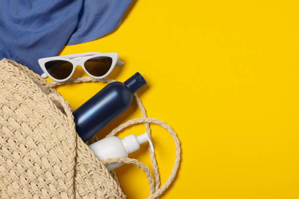 istock Flat lay composition with wicker bag and other beach accessories on yellow background. Space for text 1870557039