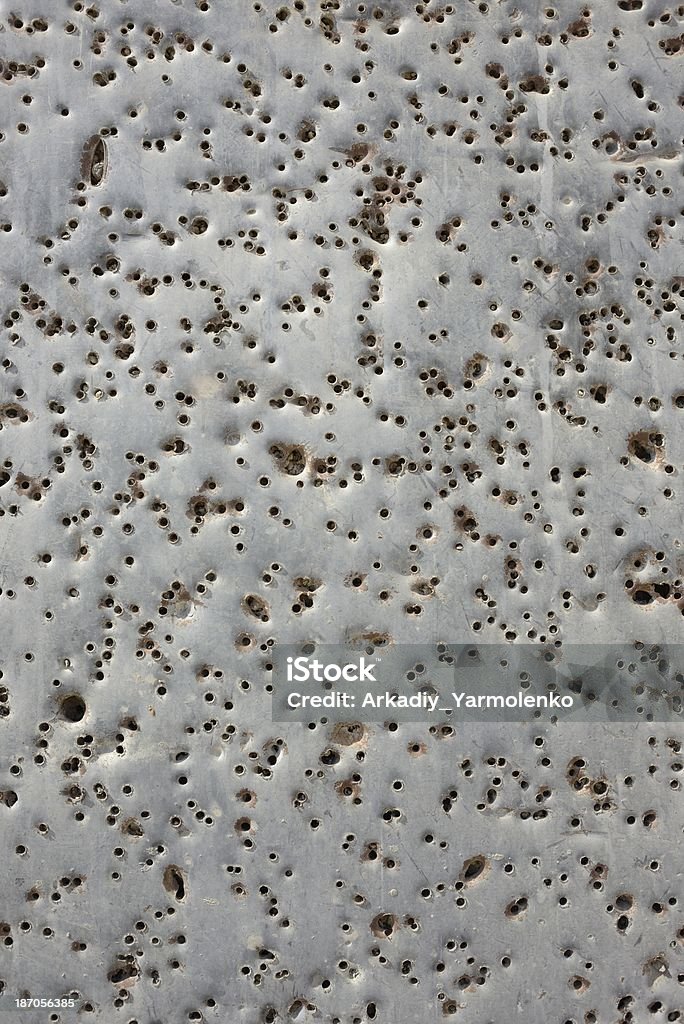 Bullet holes Metal surface with holes from bullets. Torn Stock Photo