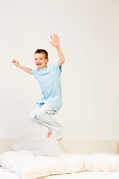 istock Boy Jumping On A Bed 187056498