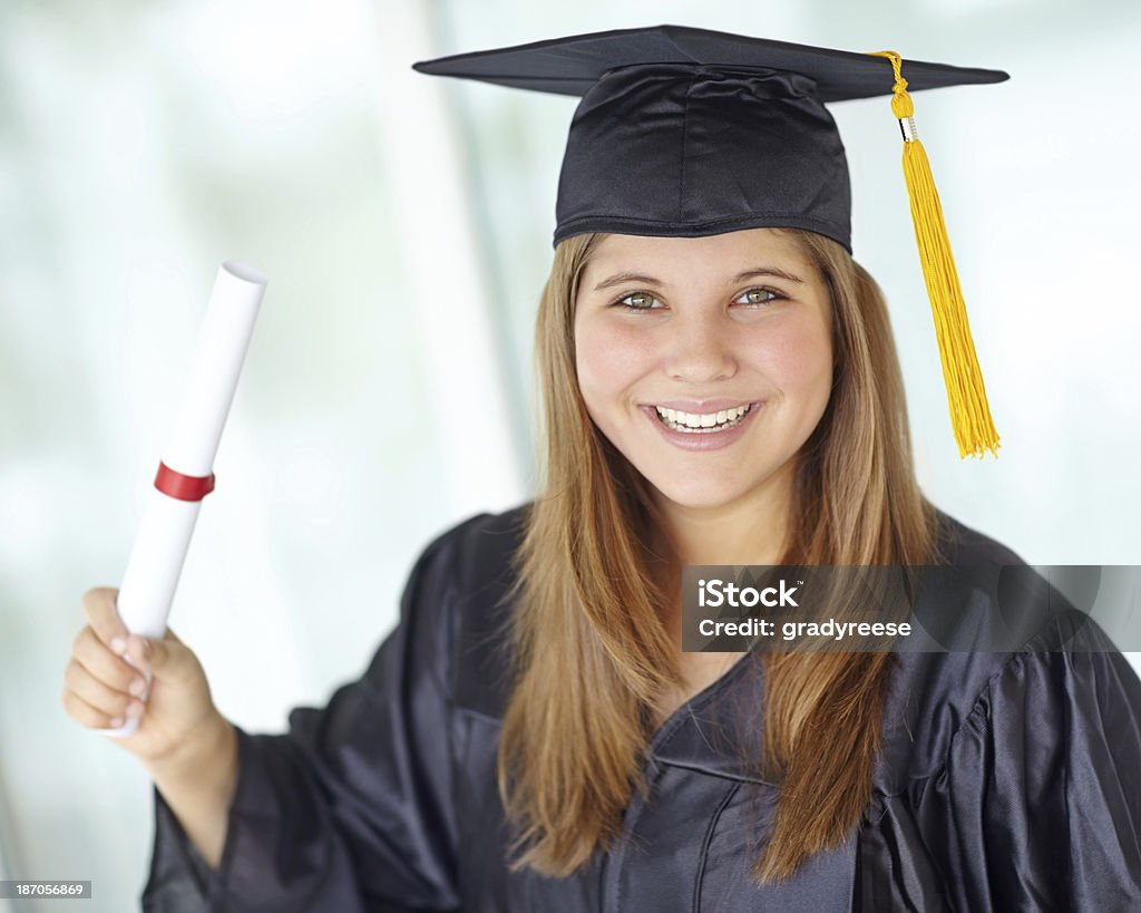 The future is mine! A pretty college student in her graduation gown showing you her degree 18-19 Years Stock Photo