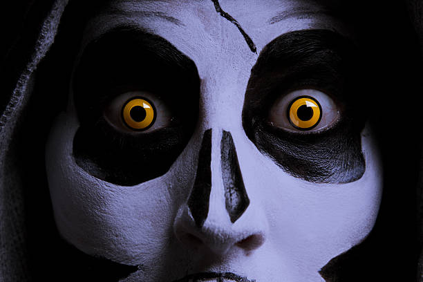 A close up of a scary face painted for Halloween.